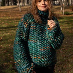 Green melange oversized wool sweater styled outdoors as a warm winter pullover.