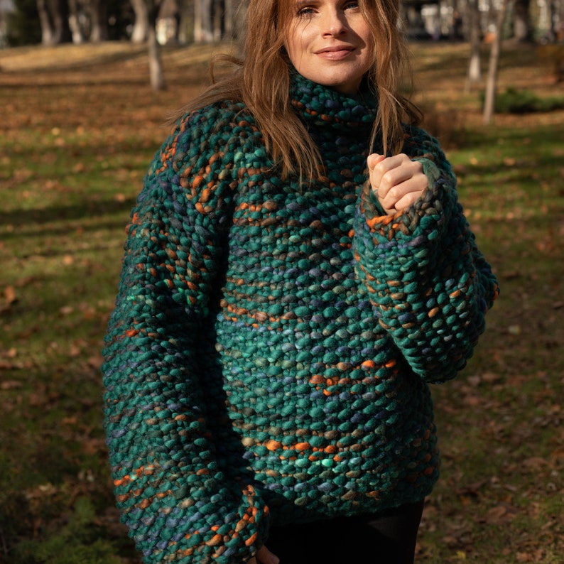 Green melange oversized wool sweater styled outdoors as a warm winter pullover.