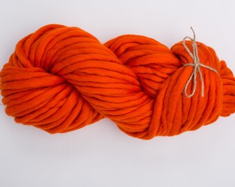 May include: A large skein of bright orange yarn, tied with a natural twine string.