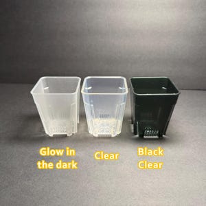 May include: Three square plastic plant pots in the image. One is clear, one is black clear, and one is glow in the dark. The text on the image says "Glow in the dark", "Clear", and "Black Clear".