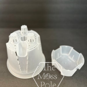 May include: Two clear plastic plant pots, one with a cylindrical shape and drainage holes, and a separate tray. The text "The Moss Pole" is visible on the image.