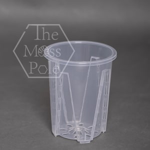 May include: A clear plastic plant pot with drainage holes and a grid pattern around the sides. The pot is designed for use with hydroponic systems.