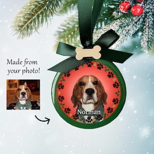 May include: A round, green Christmas ornament with a red and white background. The ornament features a photo of a dog with the name "Norman" printed below the image.