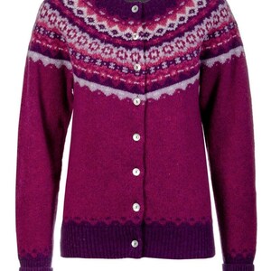 Front image of fuchsia pink Crathie fair isle cardigan with magenta and lilac pattern. Showing shell buttons