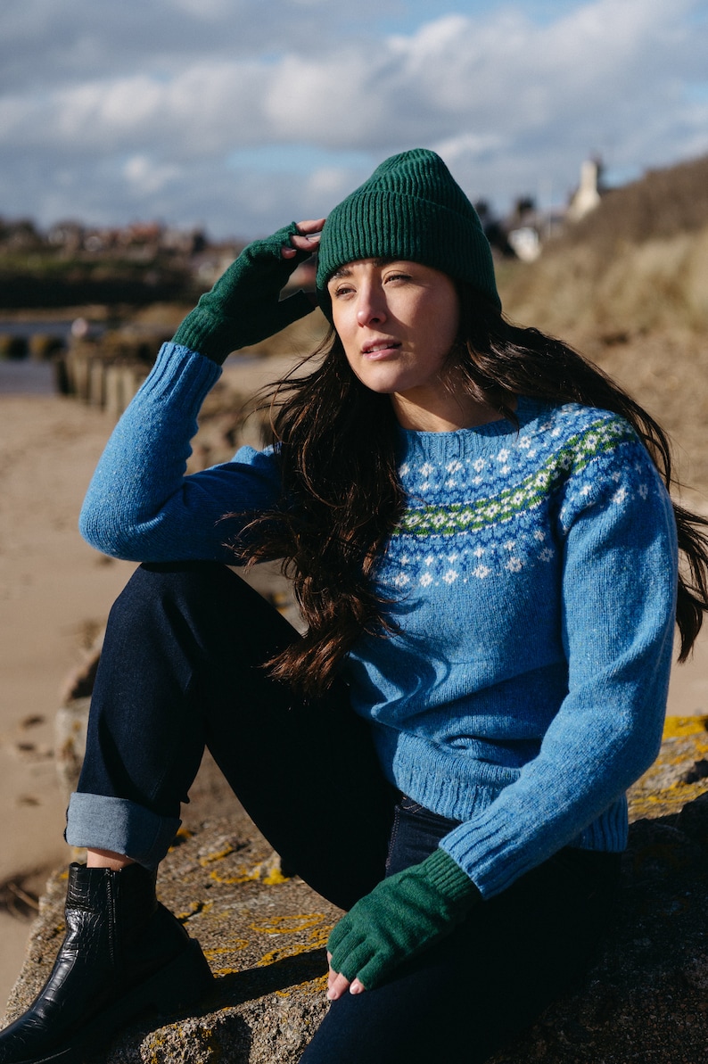 Sky blue fair isle wool jumper with green pattern at yoke
