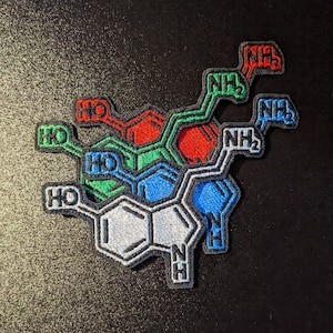 May include: A colorful embroidered patch depicting a chemical structure with the letters 'HO' and 'NH2' in various colors.