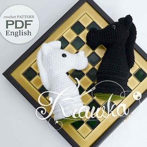 May include: A crocheted chess set featuring a white and a black knight piece on a decorative chessboard. The chess pieces are handmade and sit on a gold, green, and black checkered board. The image includes the text "crochet PATTERN PDF English".