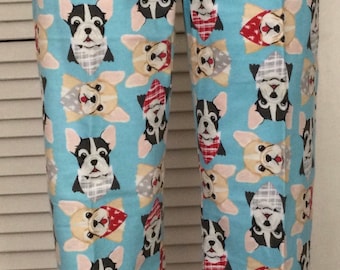 May include: Blue pajama pants with a pattern of French bulldog faces wearing bandanas. The bandanas are red, white, and gray.