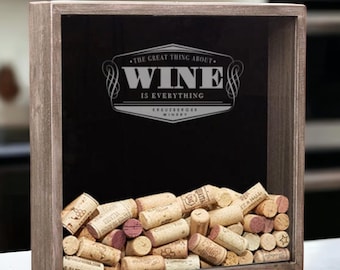 May include: A wooden box with a glass front filled with wine corks. The box has a black chalkboard background with the text "The great thing about wine is everything." printed in silver.