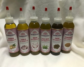 May include: Six glass bottles of hair growth oil with different natural ingredients. The bottles are labeled with the ingredient name and "Hair Growth Oil". The ingredients are ginger, garlic, onion, aloe vera, chebe, and fenugreek.
