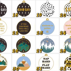 May include: A collection of sixteen circular pet ID tags featuring various designs, including lightning bolts, animal prints, mountain landscapes, and text phrases like Good Boy, Loved, If You Can Read This I Will Lick You, Kindness Is Golden, and Nap Hard Play Hard.
