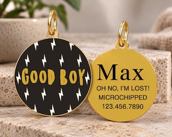 May include: Two round gold-toned metal pet ID tags. One tag features a black background with white lightning bolt patterns and the gold text GOOD BOY. The other tag is solid gold with black text reading Max, OH NO, I'M LOST!, MICROCHIPPED, and 123.456.7890.