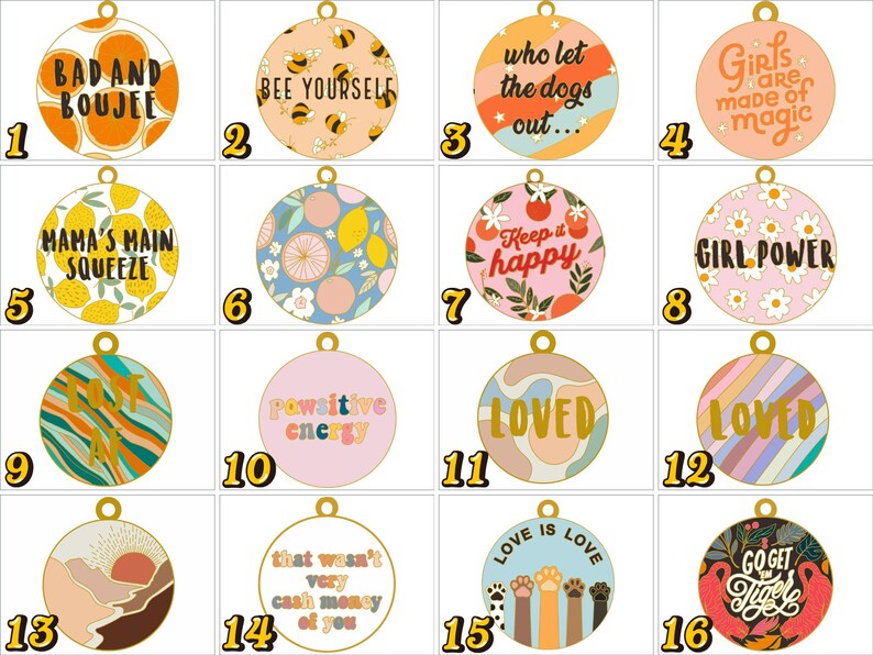 May include: A collection of sixteen circular metal charms featuring various colourful designs and text, including phrases like Bad and Boujee, Bee Yourself, Girl Power, Loved, and Love is Love, each with a small gold loop at the top for attachment.