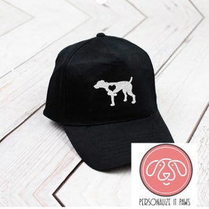 May include: Black baseball cap with a white silhouette of a dog with a heart in its chest. The text "PERSONALIZE IT PAWS" is below the image of the dog.