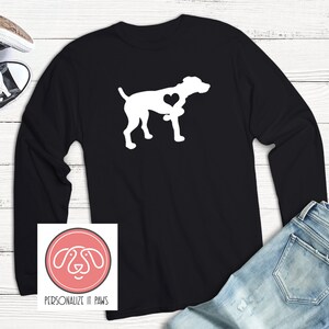 May include: Black long-sleeve t-shirt with a white silhouette of a dog with a heart in its chest. The shirt has the text "PERSONALIZE IT PAWS" on the bottom.