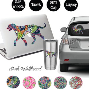 May include: A colorful paisley patterned Irish Wolfhound silhouette decal. The decal is shown on a laptop, a Yeti cup, and a car window. The decal is available in five different paisley patterns.