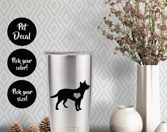 Könnte beinhalten: Ein Yeti-Becher aus Edelstahl mit einer schwarzen Silhouette eines Australian Shepherds mit einem Herzen auf der Brust. Der Becher hat das Wort "YETI" unten aufgedruckt. Das Bild enthält außerdem drei schwarze Kreise mit weißem Text, der "Pet Decal", "Wähle deine Farbe!" und "Wähle deine Größe!" lautet.