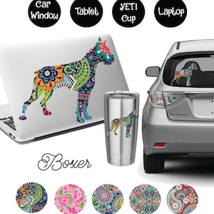 May include: A colourful paisley pattern Boxer dog silhouette decal. The decal is shown on a laptop, car window, Yeti cup and tablet. The decal is also available in five different paisley patterns.