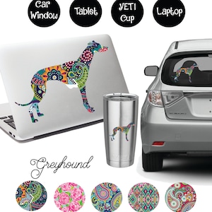 May include: A colourful paisley pattern Greyhound silhouette decal. The decal is shown on a laptop, car window, Yeti cup, and tablet. The decal is available in five different paisley patterns.