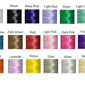 May include: A color chart of thread spools in various colors, including white, black, navy blue, light blue, green, light green, aquamarine, dark brown, red, light pink, dark pink, purple, orange, lavender, yellow, gray, silver, and beige.