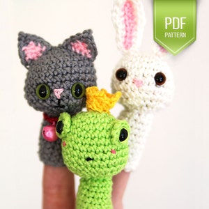 May include: Three finger puppets: a gray cat with pink ears, a white bunny with pink ears, and a green frog wearing a yellow crown.  PDF PATTERN.