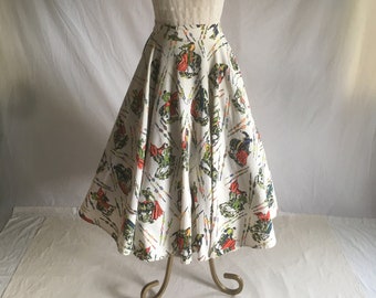 May include: A vintage dress displayed on a mannequin. The dress features a white, sheer, short-sleeved top with a high collar. The skirt is a full circle, white with a colorful print of figures and abstract lines. The dress is displayed on a gold-toned metal stand.