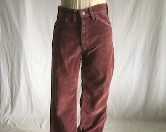 May include: A pair of wide-leg corduroy pants in a deep burgundy color. The pants have a high waist and a straight leg.
