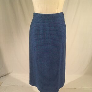 May include: A blue and green plaid skirt with a straight silhouette. The skirt is knee-length and has a simple design.