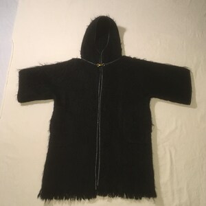 May include: A black hooded robe with a zipper closure and a fringed hem.
