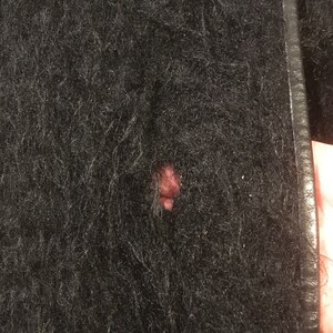May include: Black fuzzy jacket with a small hole in the fabric.