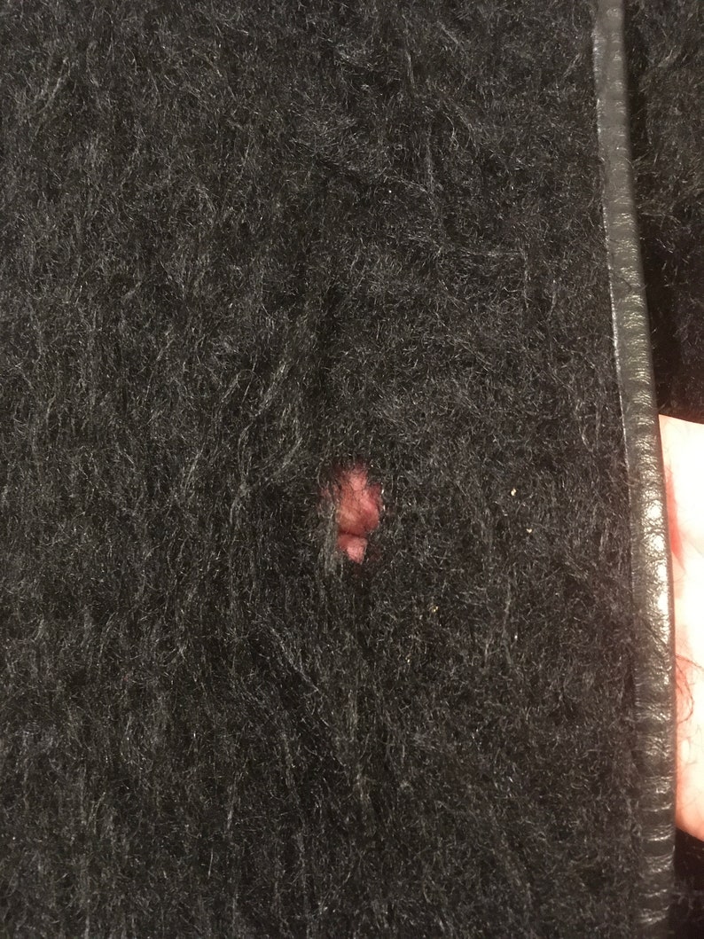May include: Black fuzzy jacket with a small hole in the fabric.
