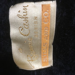 May include: A white satin label with gold lettering that reads "Bonnie Cashin Design" and "STILES-FIND CO."