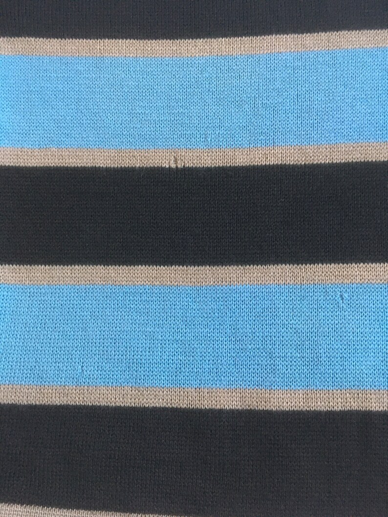 May include: Striped fabric with alternating black, light brown, and light blue stripes. The fabric has a knitted texture.