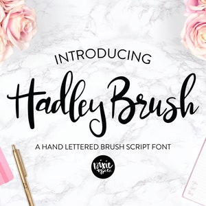 May include: Introducing Hadley Brush, a hand-lettered brush script font. The font is shown in black on a white marble background with pink roses and notebooks.