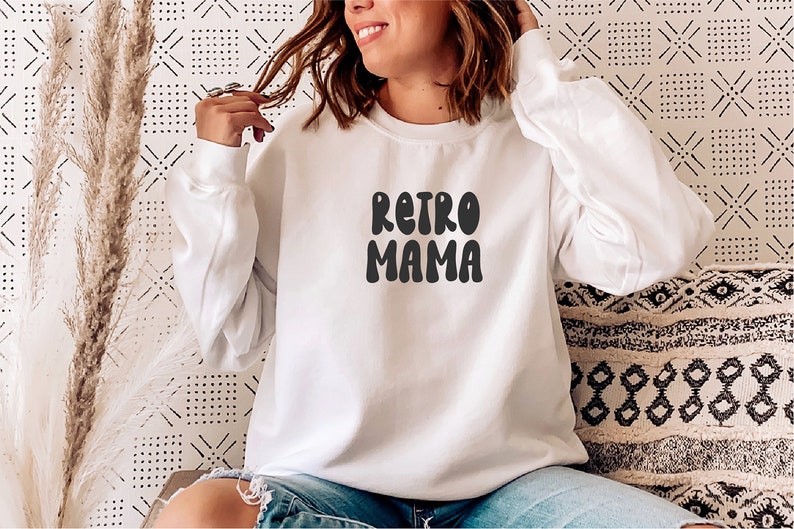 May include: White sweatshirt with the text "Retro Mama" in black, retro-style lettering.