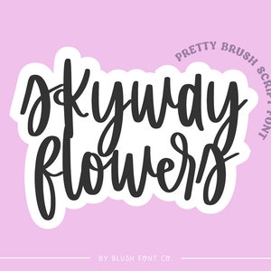 May include: A pink background with a white sticker featuring the text "Okay,  Flowers" in a black brush script font. The text "Pretty Brush Script Font" is written in a smaller font in a circle around the sticker. The text "By Blush Font Co." is written in a smaller font at the bottom of the image.