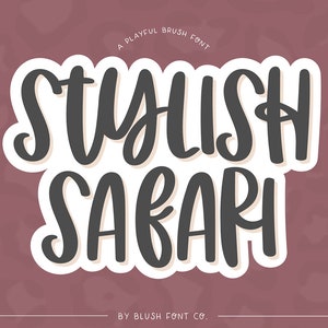 May include: A playful brush font design with the text "Stylish Safari" in a white oval with a gray outline. The text is in a bold, handwritten style. The background is a pink and white abstract pattern.