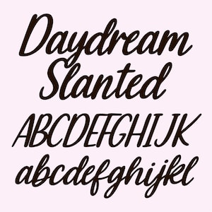 May include: A light pink background with the words "Daydream Slanted" in a dark brown, cursive font. Below, the uppercase and lowercase alphabet are displayed in the same font.