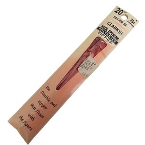 May include: A vintage package of a 20-inch red polyester neck opening zipper by Clark's. The package is a light peach color with text that reads "the flexible coil zipper that flows with the figure."