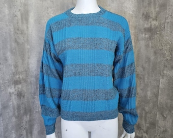 May include: A blue and gray striped sweater with long sleeves and a crew neck.