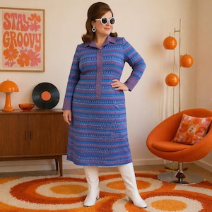 May include: A vintage-style, long-sleeved dress in shades of blue and purple with a geometric pattern. The dress features a collared neckline, a button-down front, and a knee-length hemline. The model is wearing white boots. The background includes a retro-style poster.