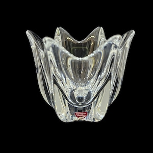 May include: A clear glass tulip-shaped bowl with a red Orrefors Sweden logo on the bottom.