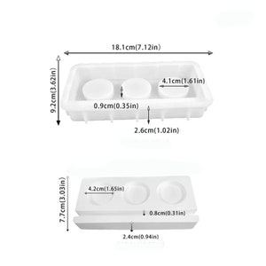 May include: Two white silicone molds for making round soap or candle shapes. The larger mold is 7.12 inches wide, 3.62 inches tall, and 1.02 inches deep. The smaller mold is 3.03 inches tall, 1.65 inches wide, and 0.94 inches deep.