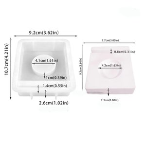 May include: Two white silicone molds for making soap or resin crafts. The larger mold is 9.2 inches wide, 10.7 inches tall, and 2.6 inches deep. The smaller mold is 7.7 inches wide, 9.3 inches tall, and 2.3 inches deep. Both molds have a circular indentation in the center.