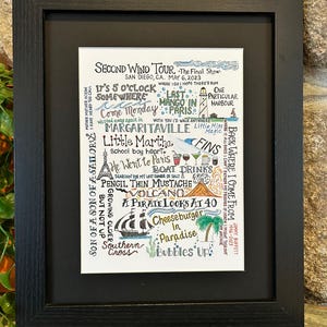 May include: Black framed art print featuring handwritten song lyrics and phrases like "Margaritaville," "Cheeseburger in Paradise," and "It's 5 O'Clock Somewhere." The artwork includes a ship, palm tree, and cocktail illustrations. The print is a tribute to Jimmy Buffett.