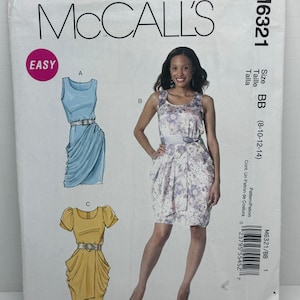 May include: McCall's sewing pattern M6321 featuring three dress designs. The cover shows illustrations of the dresses, including a blue sleeveless dress, a floral print dress, and a yellow dress with short sleeves. The word "EASY" is in a pink circle.