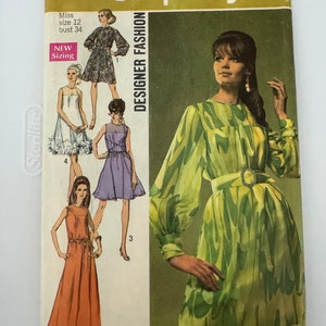 May include: A vintage Simplicity sewing pattern for a dress, featuring four different styles. The pattern is for size 12, bust 34. The pattern is called "Designer Fashion" and is numbered 8184. The price is $1.00.