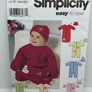 May include: Simplicity pattern 5720 easy-to-sew baby sleep sack and hat pattern. The pattern includes six different designs with various embroidery details. The pattern is designed by Karen Z.