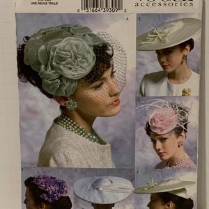 May include: A vintage Vogue Accessories sewing pattern for five different hat styles. The pattern is for one size and includes instructions for making a variety of hats, including a cloche hat, a pillbox hat, and a wide-brimmed hat.