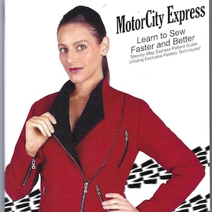 May include: A red and black leather jacket with a zip fastening. The jacket is modelled by a woman with a neutral expression. The text "MotorCity Express #222 by Janet Pray" is printed at the bottom of the image.